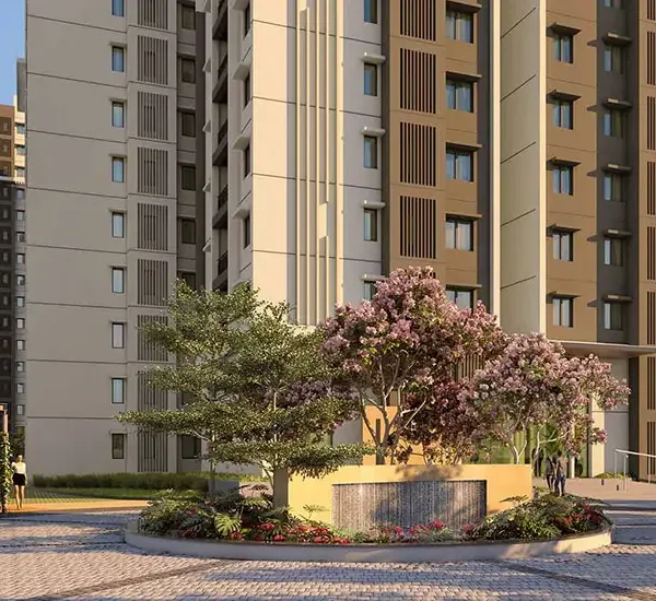 Towers behind a flowering tree and a water wall at Brigade Citadel