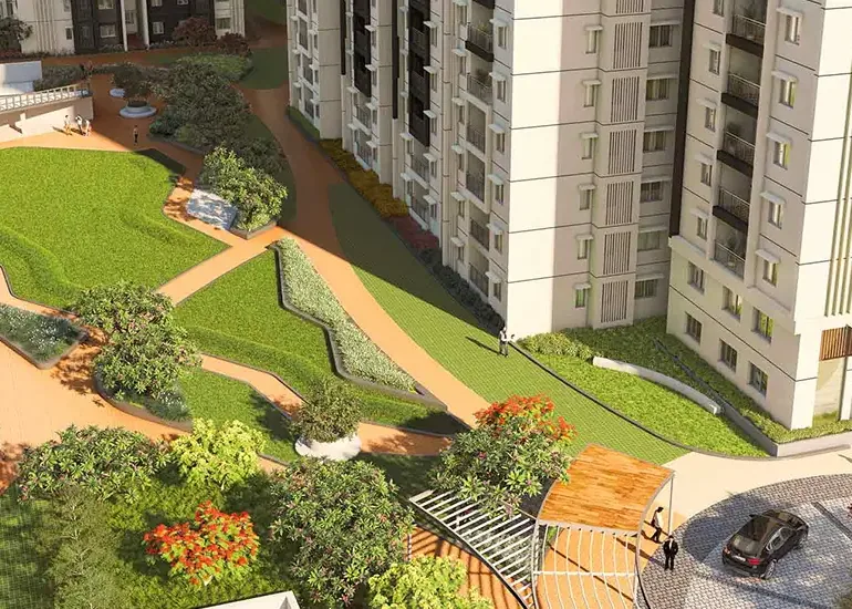 Apartment towers above landscaped lawns and winding walkways at Brigade Citadel
